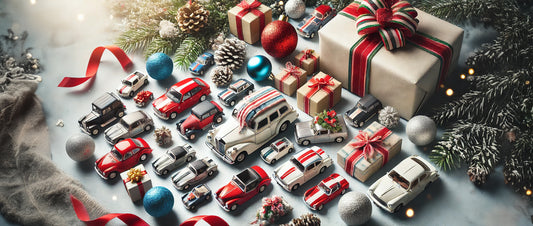 A festive arrangement of 1:64 scale diecast cars surrounded by holiday decorations, including wrapped gifts, ornaments, pinecones, and ribbons. The cars are displayed on a cool-toned surface, evoking a cheerful and celebratory holiday spirit.